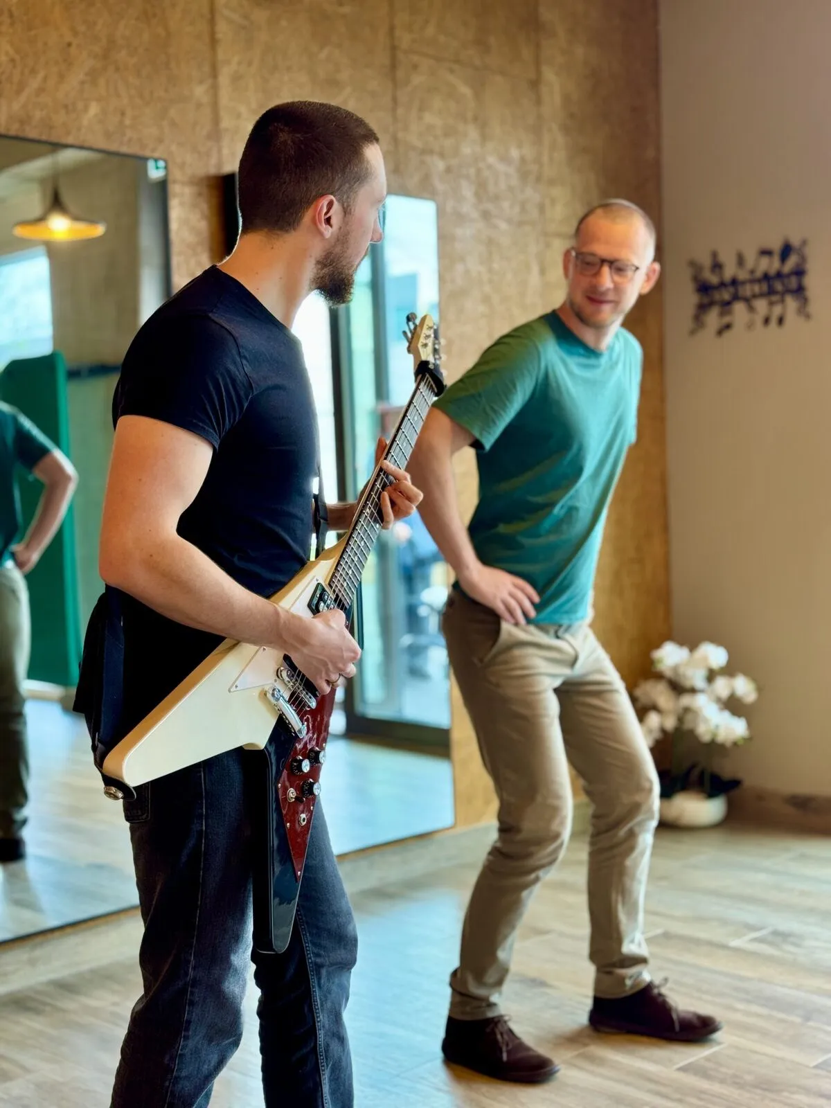 Sébastien guide le geste d'un guitariste au cabinet
